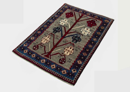Corner detail of 2000s Persian Gabbeh rug showing border pattern and Wool pile