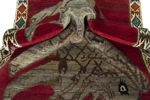 Corner detail of 2000s Persian Gabbeh rug showing border pattern and Wool pile