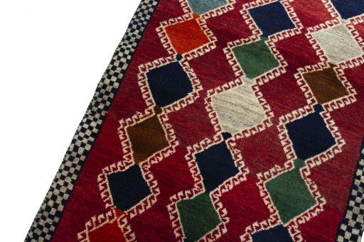 Backside of handmade 2000s Persian Gabbeh rug showing knot structure and weave density