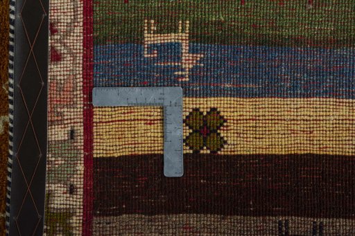 Corner detail of 2000s Persian Gabbeh rug showing border pattern and Wool pile