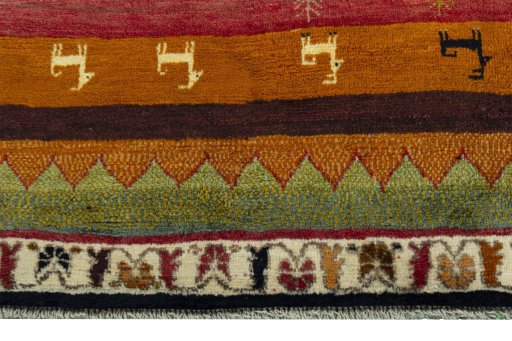 Backside of handmade 2000s Persian Gabbeh rug showing knot structure and weave density
