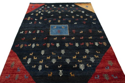 Surface texture of 2000s Persian Gabbeh rug with natural Wool and intricate pattern