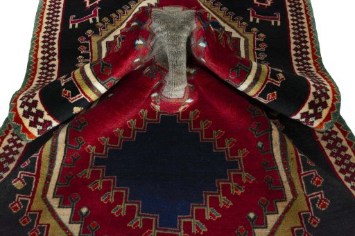 Corner detail of 2000s Persian Gabbeh rug showing border pattern and Wool pile
