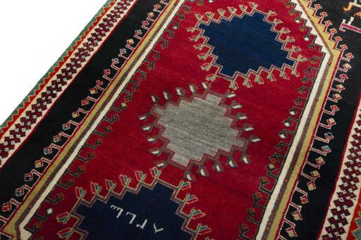 Backside of handmade 2000s Persian Gabbeh rug showing knot structure and weave density