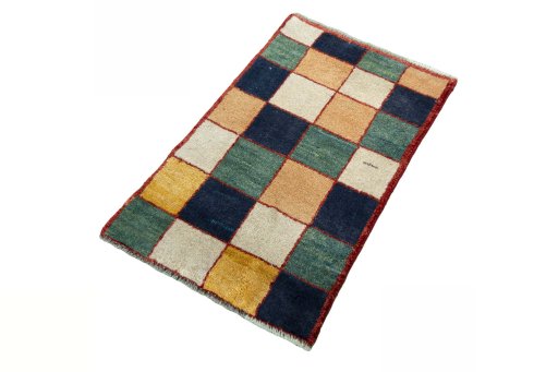 Corner detail of 2000s Persian Gabbeh rug showing border pattern and Wool pile