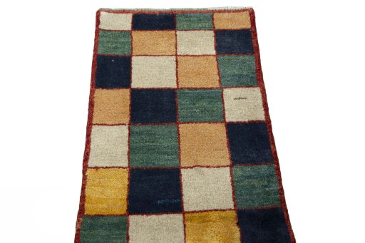 Surface texture of 2000s Persian Gabbeh rug with natural Wool and intricate pattern