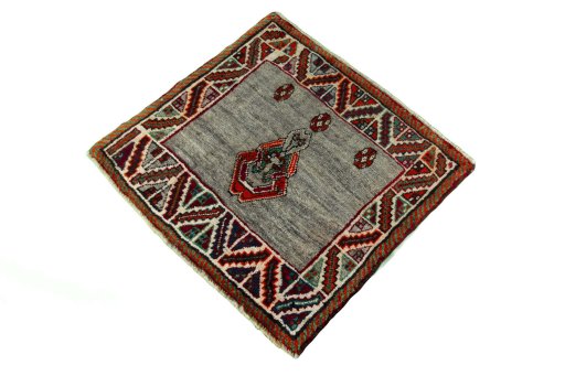 Corner detail of 2000s Persian Gabbeh rug showing border pattern and Wool pile