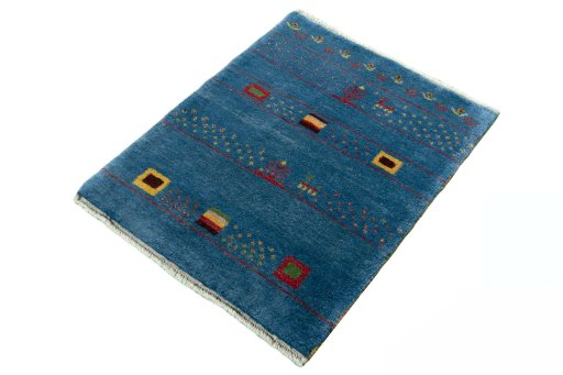 Corner detail of 2000s Persian Gabbeh rug showing border pattern and Wool pile