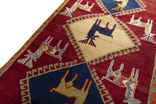 Backside of handmade 2000s Persian Gabbeh rug showing knot structure and weave density