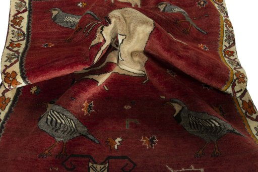 Corner detail of 2000s Persian Gabbeh rug showing border pattern and Wool pile