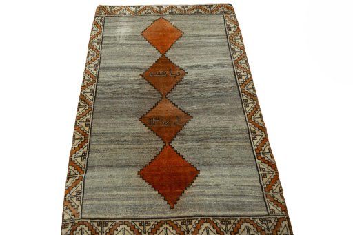 Surface texture of 2000s Persian Gabbeh rug with natural Wool and intricate pattern