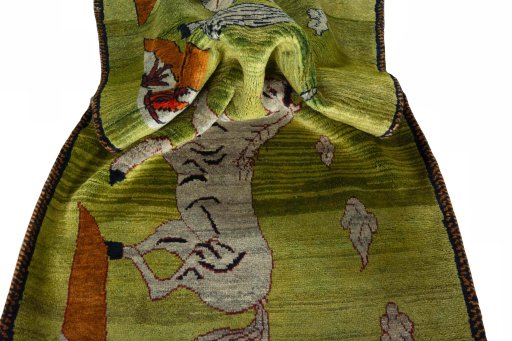 Corner detail of 2000s Persian Gabbeh rug showing border pattern and Wool pile