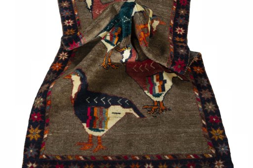 Corner detail of 2000s Persian Gabbeh rug showing border pattern and Wool pile