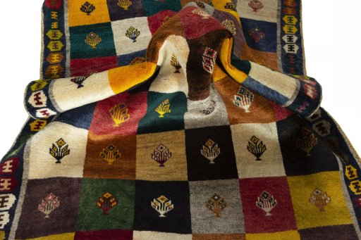 Corner detail of 2000s Persian Gabbeh rug showing border pattern and Wool pile