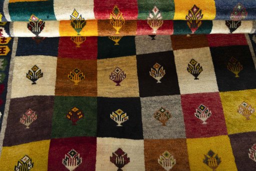 Full view of 2000s Persian Gabbeh rug from Iran / Persia, 192 × 127 cm in Multi Color tones