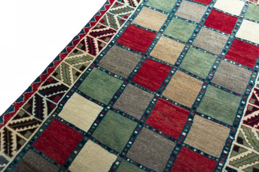 Backside of handmade 2000s Persian Gabbeh rug showing knot structure and weave density