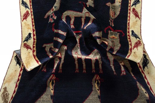 Corner detail of 2000s Persian Gabbeh rug showing border pattern and Wool pile