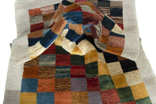 Corner detail of 2000s Persian Gabbeh rug showing border pattern and Wool pile