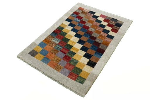 Corner detail of 2000s Persian Gabbeh rug showing border pattern and Wool pile
