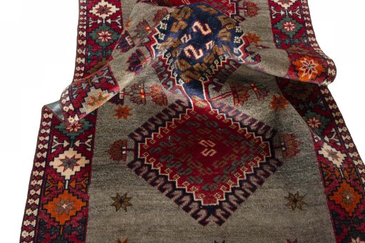 Corner detail of 2000s Persian Gabbeh rug showing border pattern and Wool pile