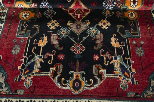 Corner detail of 2000s Persian Gabbeh rug showing border pattern and Wool pile