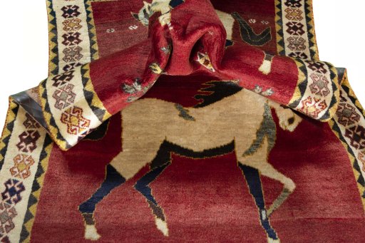 Corner detail of 2000s Persian Gabbeh rug showing border pattern and Wool pile