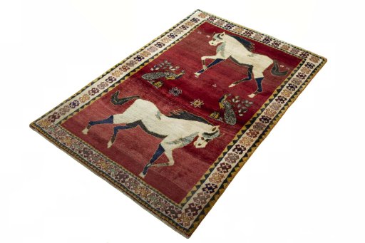 Corner detail of 2000s Persian Gabbeh rug showing border pattern and Wool pile