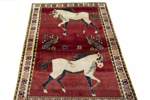 Surface texture of 2000s Persian Gabbeh rug with natural Wool and intricate pattern