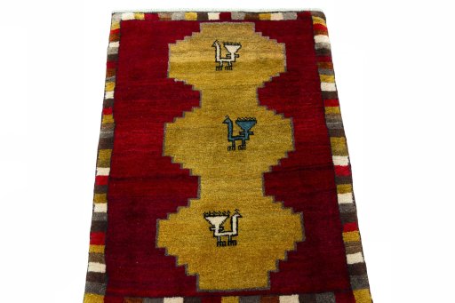 Surface texture of 2000s Persian Gabbeh rug with natural Wool and intricate pattern