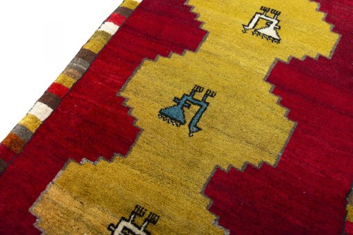 Backside of handmade 2000s Persian Gabbeh rug showing knot structure and weave density