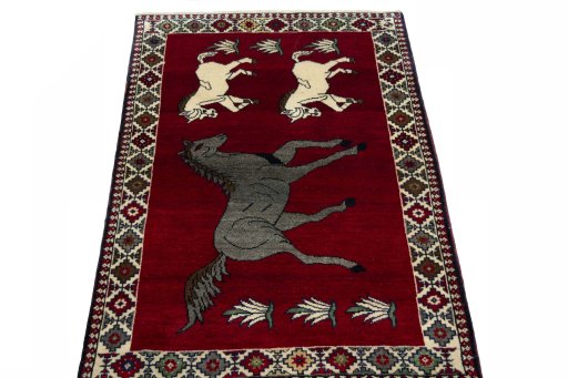 Surface texture of 2000s Persian Gabbeh rug with natural Wool and intricate pattern