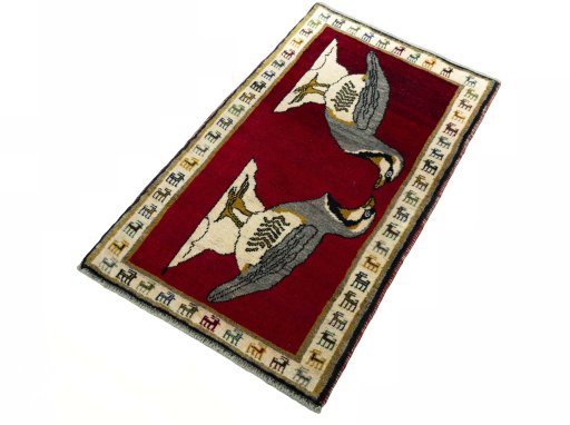 Corner detail of 2000s Persian Gabbeh rug showing border pattern and Wool pile
