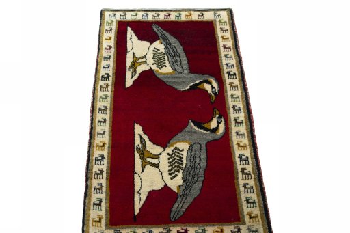 Surface texture of 2000s Persian Gabbeh rug with natural Wool and intricate pattern