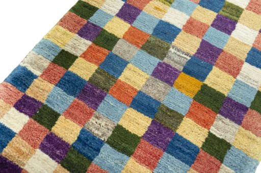 Backside of handmade 2000s Persian Gabbeh rug showing knot structure and weave density