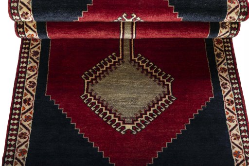 Corner detail of 2000s Persian Gabbeh rug showing border pattern and Wool pile