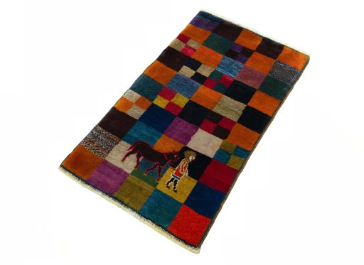 Corner detail of 2000s Persian Gabbeh rug showing border pattern and Wool pile