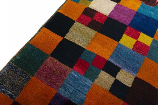 Backside of handmade 2000s Persian Gabbeh rug showing knot structure and weave density