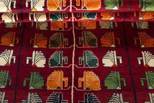 Full view of 2000s Persian Gabbeh rug from Iran / Persia, 227 × 155 cm in Red tones