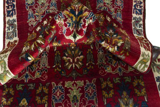 Corner detail of 2000s Persian Gabbeh rug showing border pattern and Wool pile