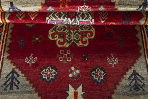 Corner detail of 2000s Persian Gabbeh rug showing border pattern and Wool pile