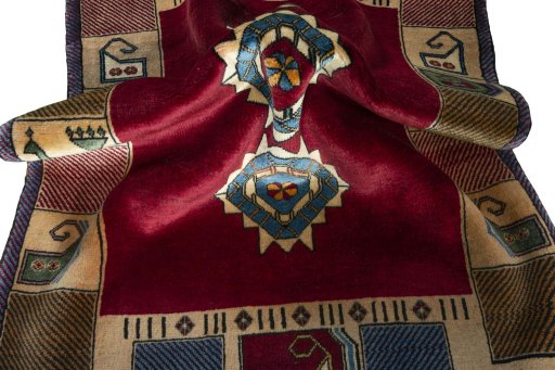 Corner detail of 2000s Persian Gabbeh rug showing border pattern and Wool pile