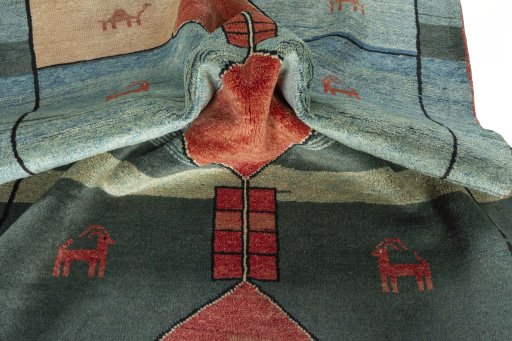 Corner detail of 2000s Persian Gabbeh rug showing border pattern and Wool pile