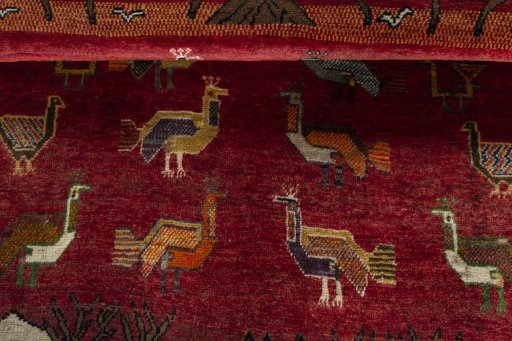 Corner detail of 2000s Persian Gabbeh rug showing border pattern and Wool pile