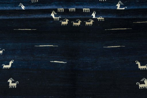 Corner detail of 2000s Persian Gabbeh rug showing border pattern and Wool pile