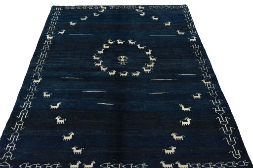 Surface texture of 2000s Persian Gabbeh rug with natural Wool and intricate pattern