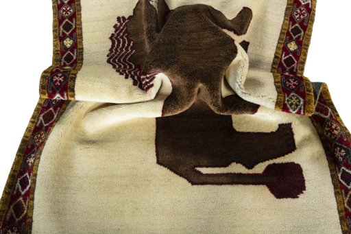 Corner detail of 2000s Persian Gabbeh rug showing border pattern and Wool pile