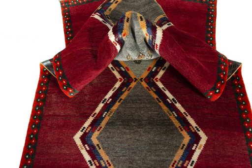 Corner detail of 2000s Persian Gabbeh rug showing border pattern and Wool pile