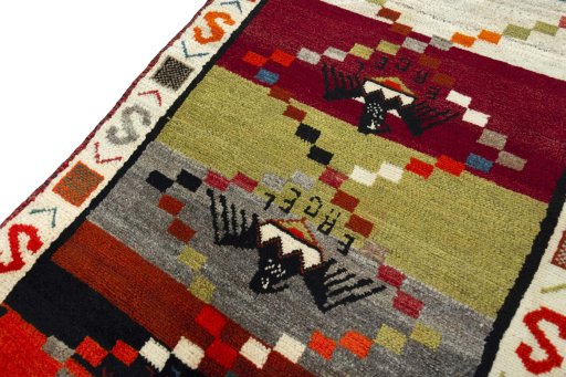 Backside of handmade 2000s Persian Gabbeh rug showing knot structure and weave density
