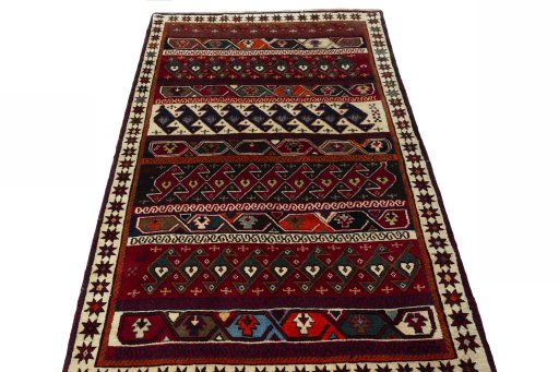 Surface texture of 2000s Persian Gabbeh rug with natural Wool and intricate pattern