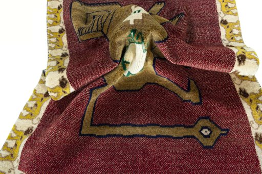 Corner detail of 2000s Persian Gabbeh rug showing border pattern and Wool pile